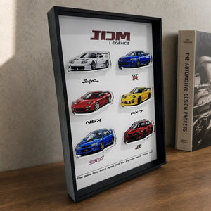 JDM Legends Car Collection 3D Framed Display — on a wood desk, showing the layered acrylic car cutouts