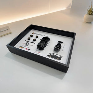 Porsche 911 GT3 992 Deconstructed Frame — laid flat on a white desk at an angle, showing the depth of the shadow box