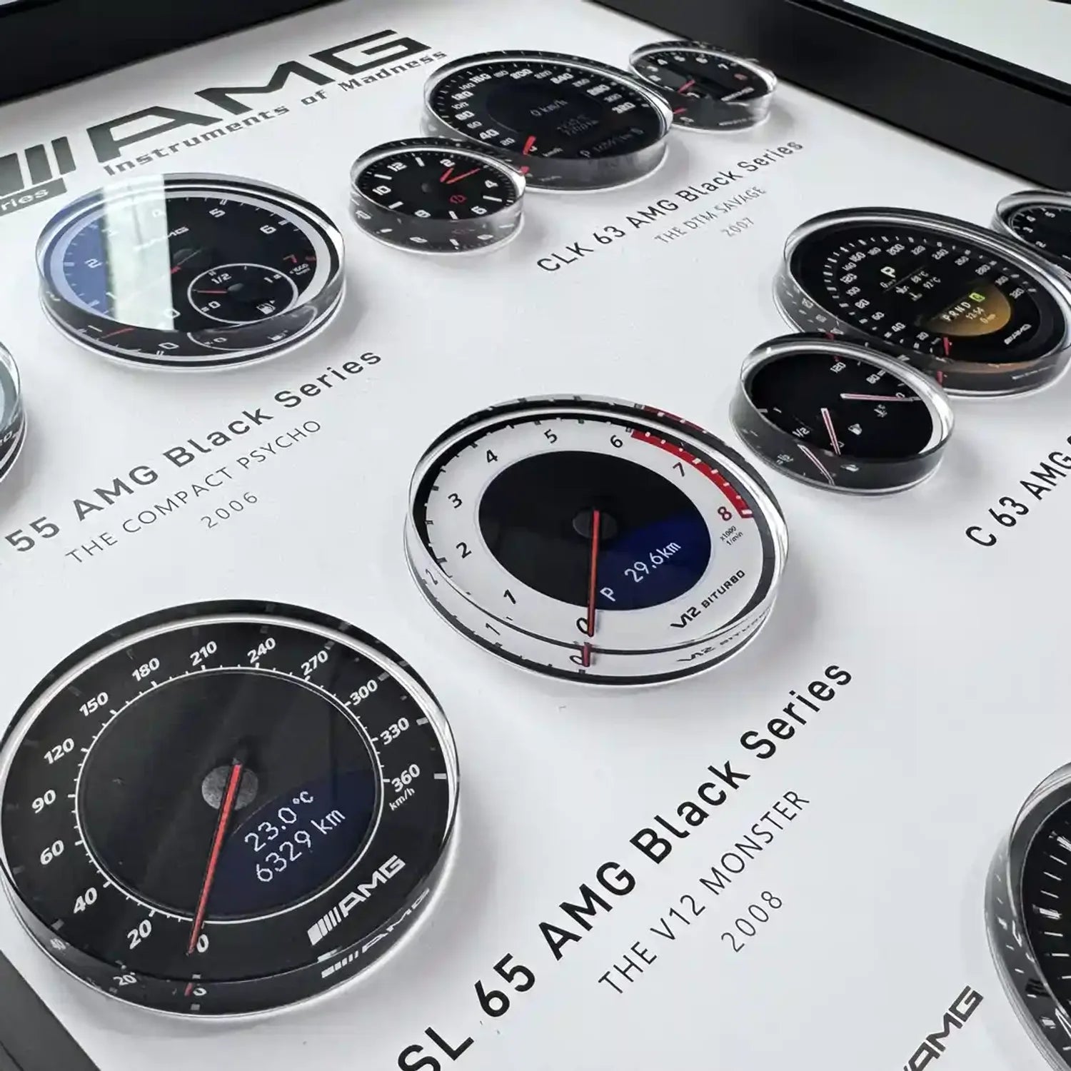 Mercedes-AMG Black Series Instruments 3D Framed Display — macro detail of the SL 65 and SLK 55 gauge faces under glazing