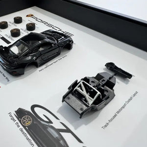 Porsche 911 GT3 992 Deconstructed Frame — macro detail of the body shell, roll cage chassis and swan-neck rear wing