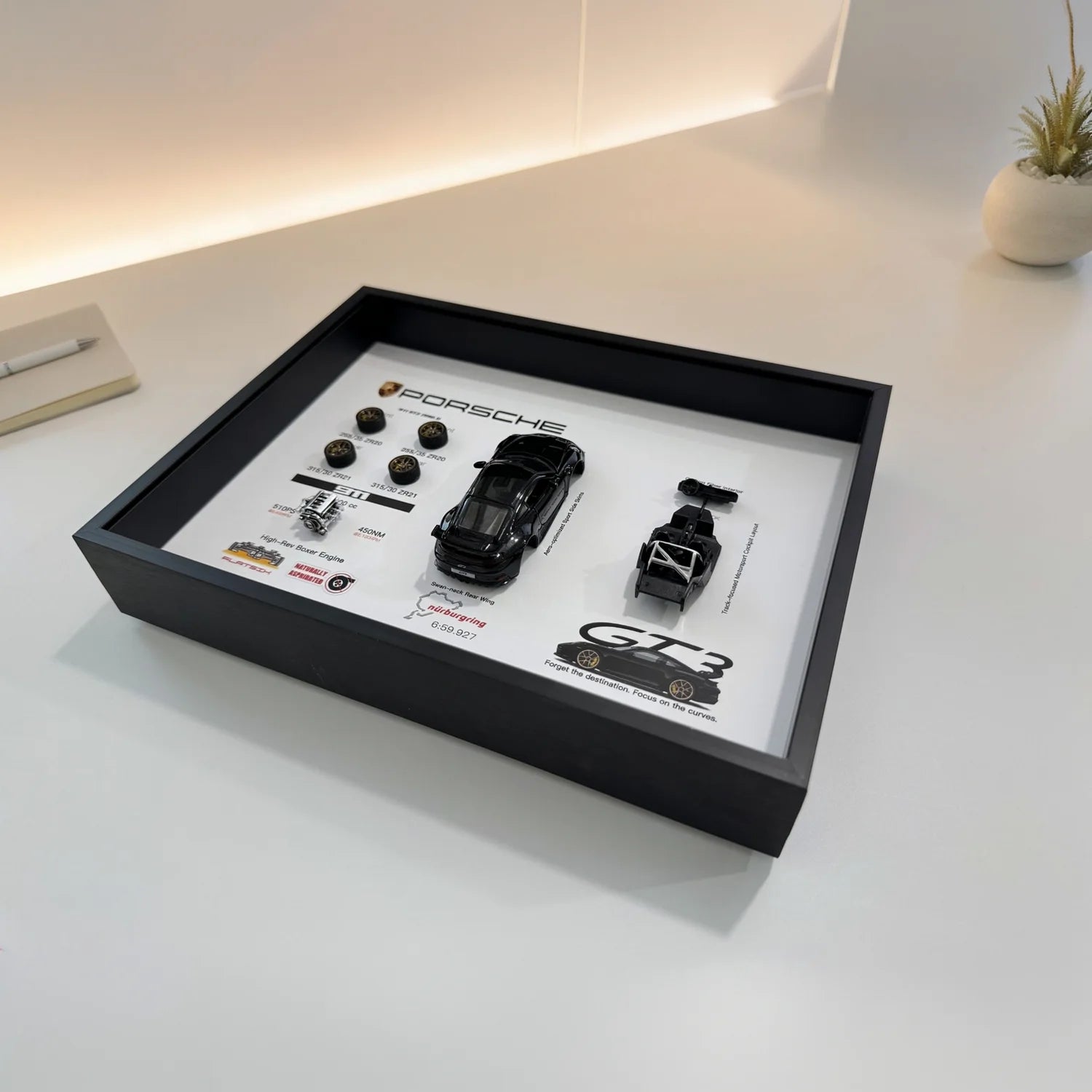Porsche 911 GT3 992 Deconstructed Frame — laid flat on a white desk at an angle, showing the depth of the shadow box