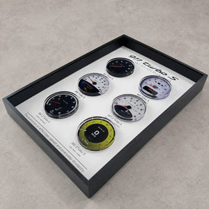 Porsche 911 Turbo S Tachometer Evolution 3D Framed Display — flat lay on grey concrete showing all six tachometer faces