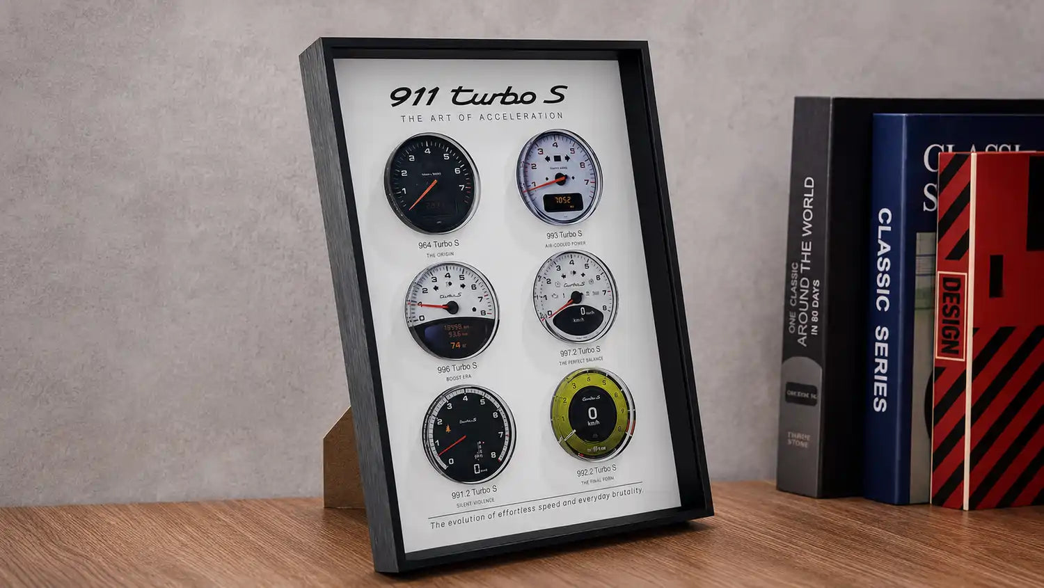 Porsche 911 Turbo S Tachometer Evolution 3D Framed Display — standing on a wood desk beside books, showing 3D layered depth
